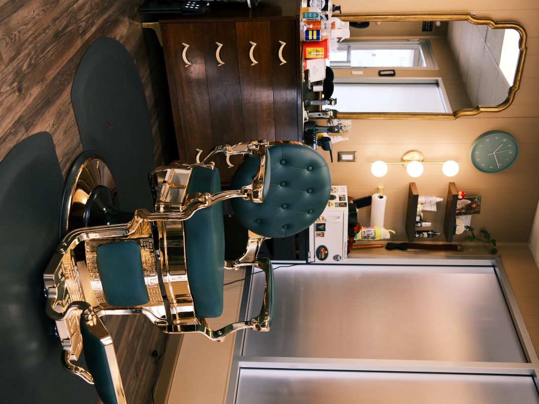The antique green and gold barber chair