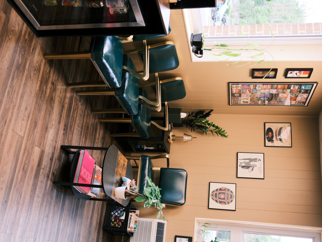 The waiting area with green leather chairs